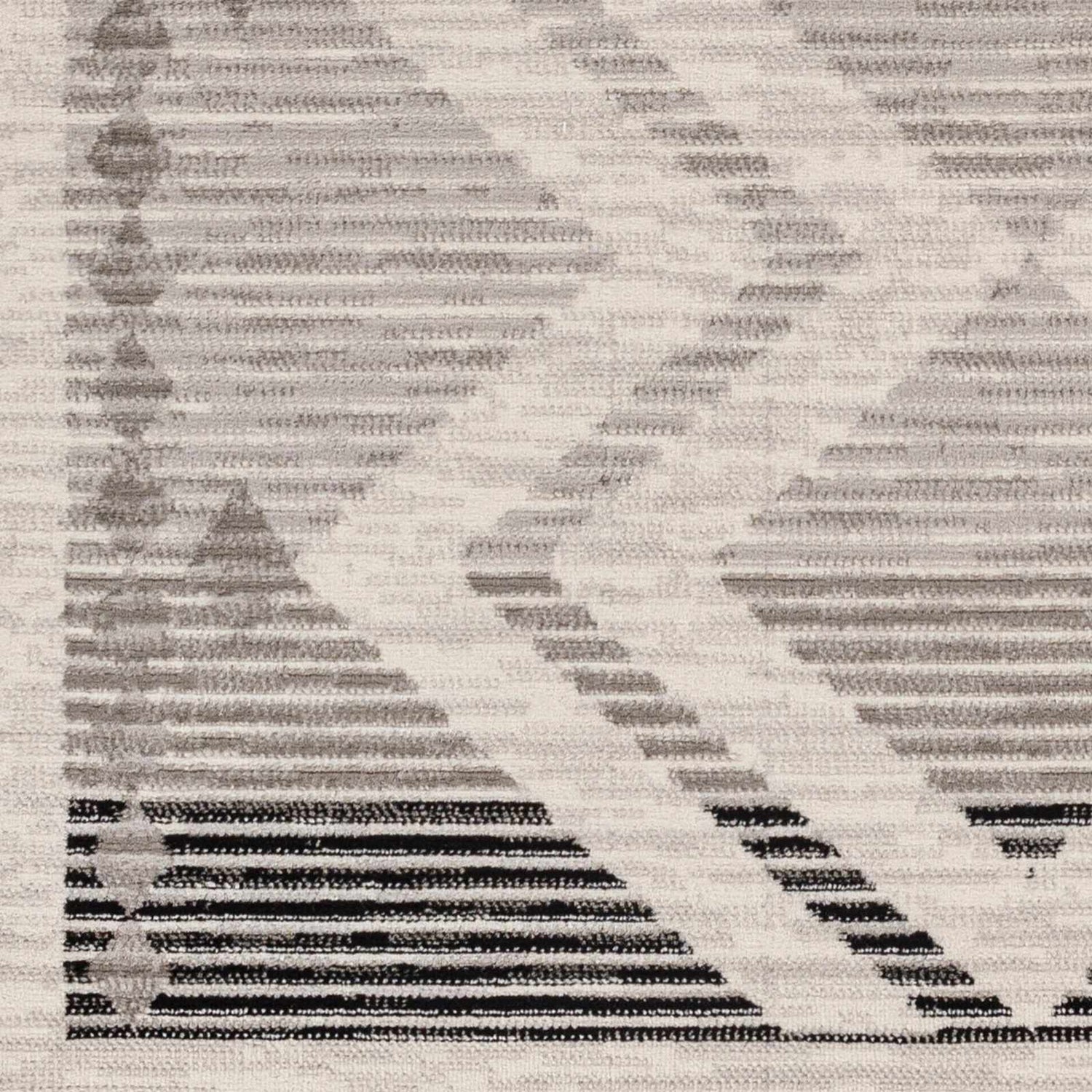 Close up of the Rory Area Rug featuring a geometric pattern in dark gray, gray, and natural. Swatch