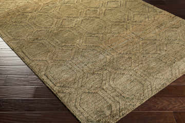 Close-up of the brown and light beige Roseau Jute Carpet showing its hand-knotted texture and farmhouse-style geometric pattern. Corner