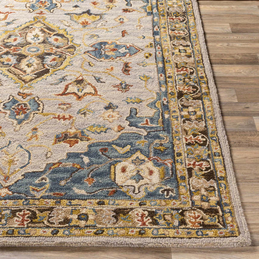Close-up of the Rozel Area Rug showcasing its traditional, oriental design, wool texture, and colors: beige, blue, brown, and mustard. Front