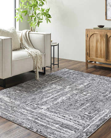 Living room scene with a Roald Gray Area Rug, light sofa, wood cabinet, and dark wood floors. Roomscene-Rectangle