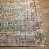 Close-up of the Rio Washable Area Rug showing its traditional, distressed pattern in rust, blue, and beige on wood floor. Front