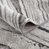 Close-up of the Live Marble Dark Gray Area Rug showing its charcoal, gray, and off-white contemporary pattern. Fold