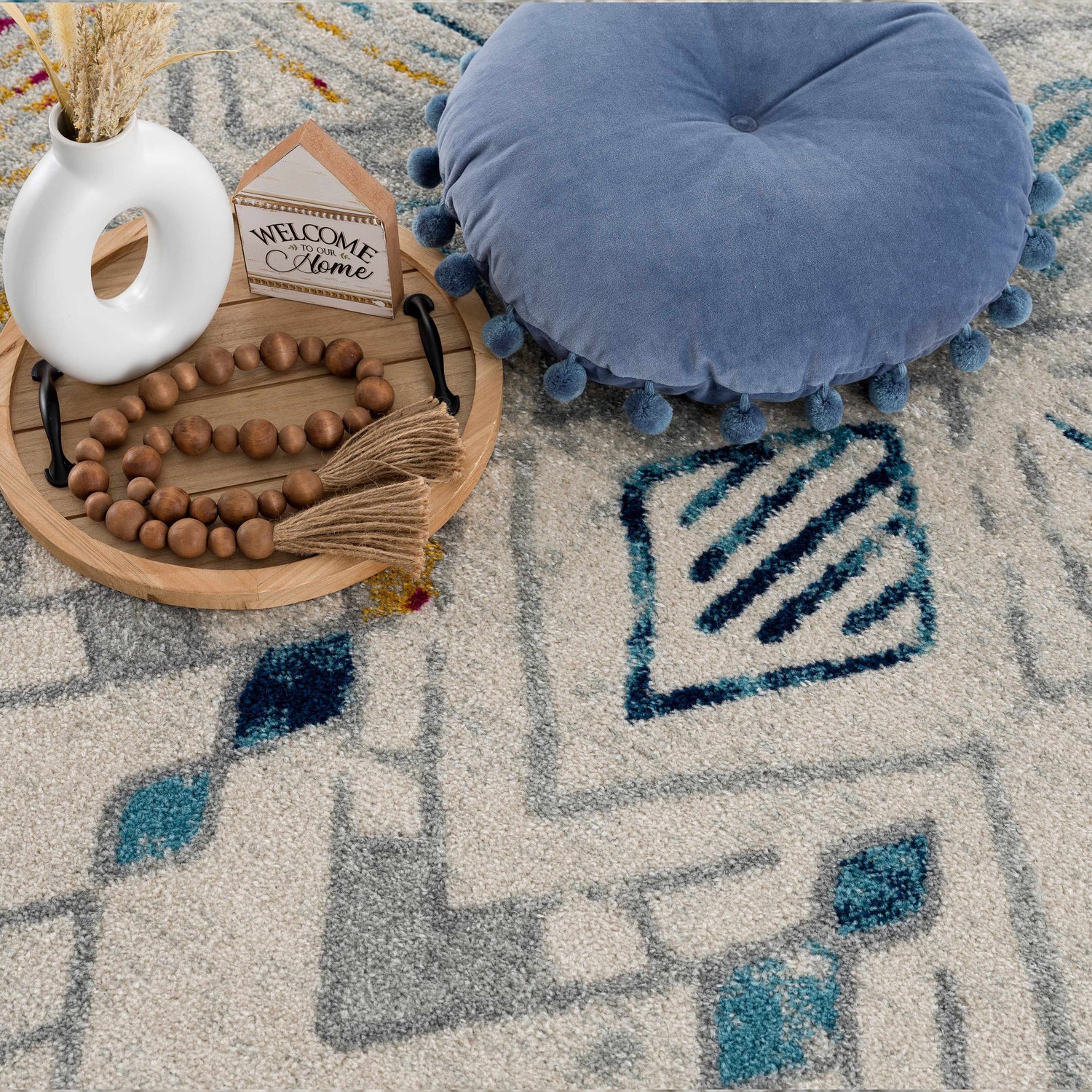 Close-up of Istanbul Aztec Area Rug showing off white, blue, gray, and mustard colors with a geometric Southwestern pattern. Styleshot