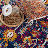 Close-up of the Istanbul Vintage Navy Area Rug, showcasing its navy, ivory, gold, and magenta bohemian pattern and texture. Styleshot