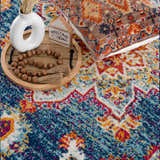 Close up of Istanbul Medallion Blue & Orange Area Rug with navy, turquoise, orange, and white bohemian pattern. Styleshot