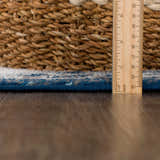 Close-up of the pile height of the Istanbul Blue Area Rug, showing ivory and navy fibers with a ruler for scale. Pile