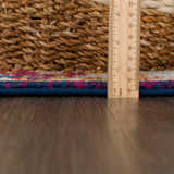 Close-up of the Istanbul Vintage Navy Area Rug showing the rug's texture, navy border, and colorful pattern. Pile