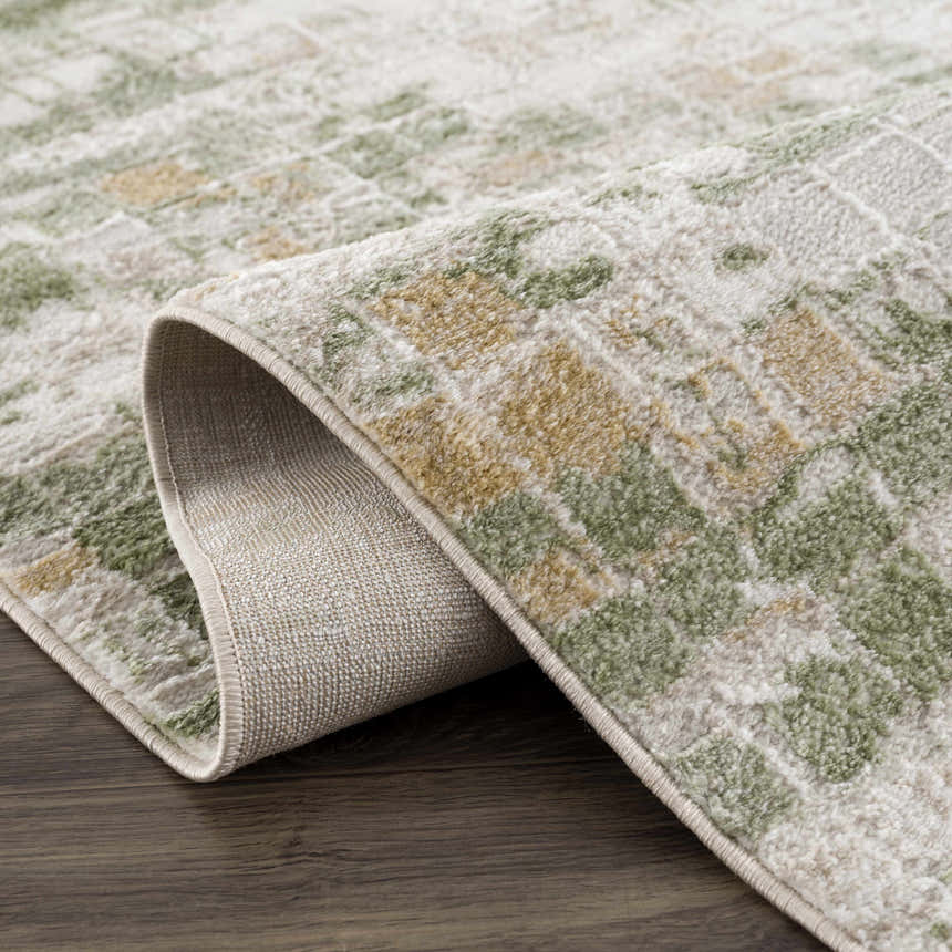 Close-up of the Liveri Green Mosaic Rug, showcasing its abstract design, green and beige tones, and soft texture. Fold