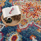 Close-up of the Istanbul Medallion Blue & Orange Area Rug, showcasing its bohemian medallion pattern and vibrant navy, turquoise, and orange colors. Styleshot