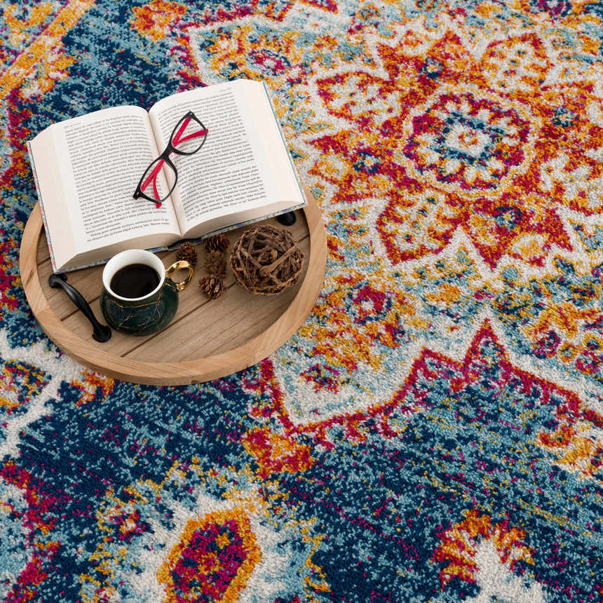 Close-up of the Istanbul Medallion Blue & Orange Area Rug, showcasing its bohemian medallion pattern and vibrant navy, turquoise, and orange colors. Styleshot