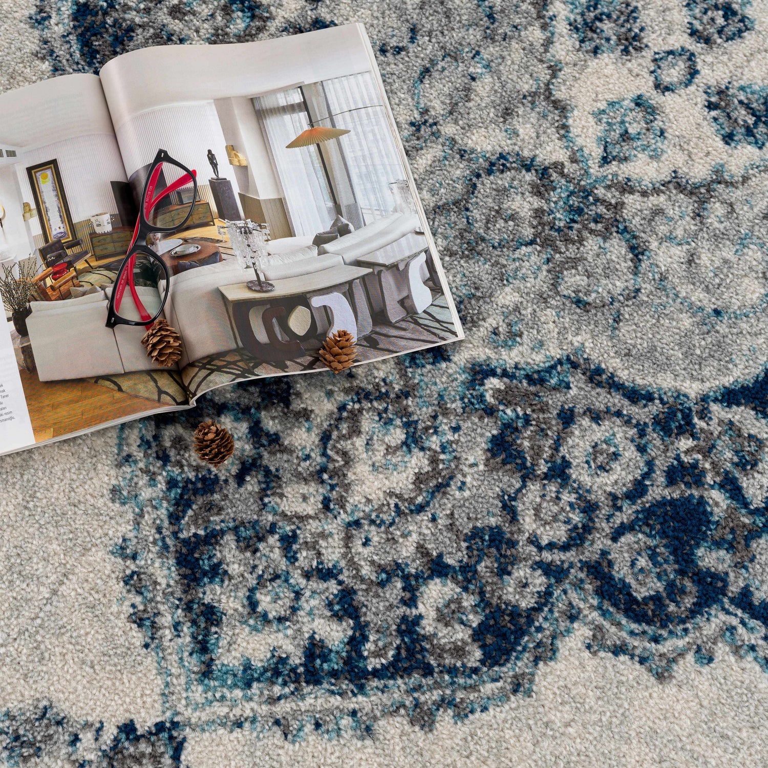 Close-up of the Istanbul Blue Area Rug showing its ivory, navy, and gray bohemian pattern and plush texture. Styleshot