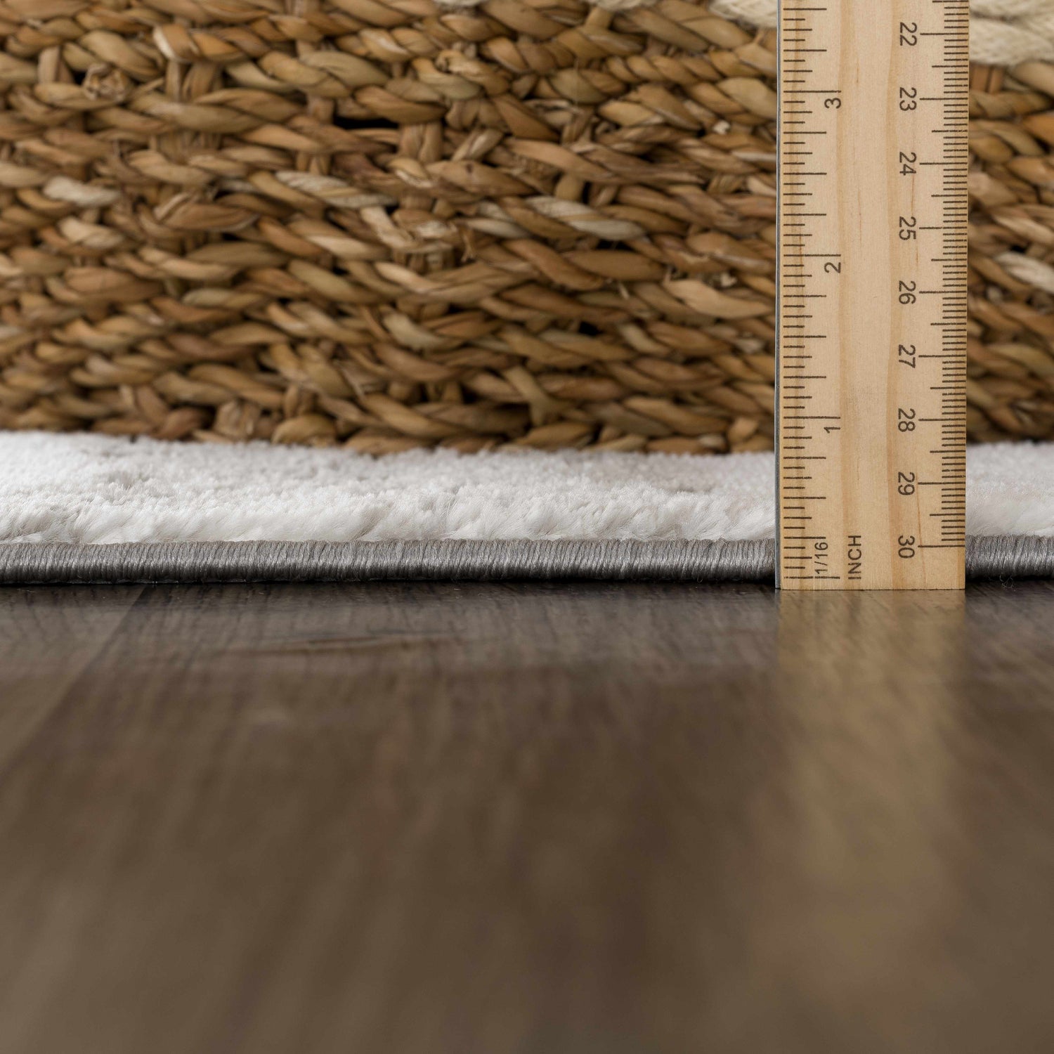 Close-up of the Live Marble Gray Area Rug showing its texture, gray edge, and pile height with a ruler. Pile