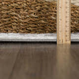 Close-up of the Liverpool Dark Gray Area Rug showing the pile height with a ruler and a woven basket. Pile