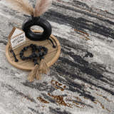 Close-up of Live Marble Gray Area Rug showing charcoal, light gray, and rust abstract design. Styleshot