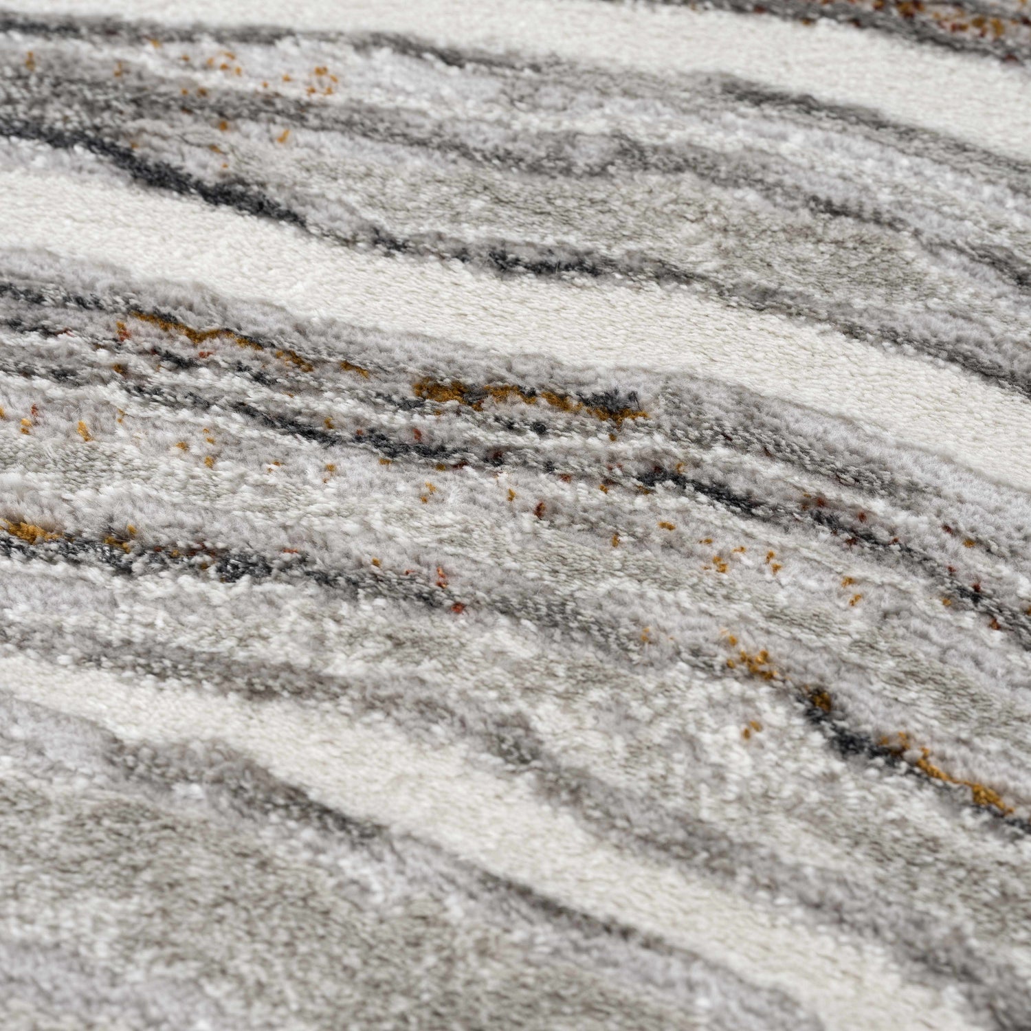 Close-up of the Live Marble Dark Gray Area Rug. Features charcoal, light gray, off-white, and rust colors in a wavy, textured pattern. Texture