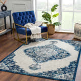Living room scene with a blue chair and the Istanbul Blue Area Rug featuring a Persian-inspired design. Roomscene-Rectangle