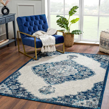 Living room scene with a blue chair and the Istanbul Blue Area Rug featuring a Persian-inspired design. Roomscene-Rectangle