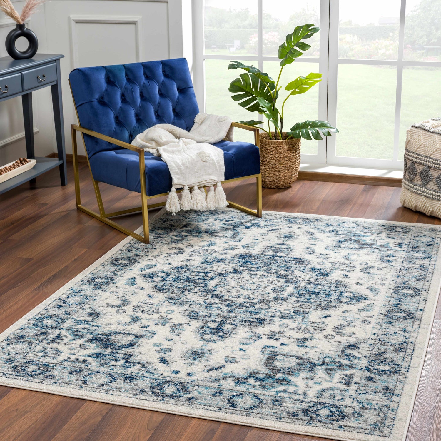 Living room scene with Istanbullu Blue Area Rug, blue velvet chair, and natural light from a large window. Roomscene-Rectangle