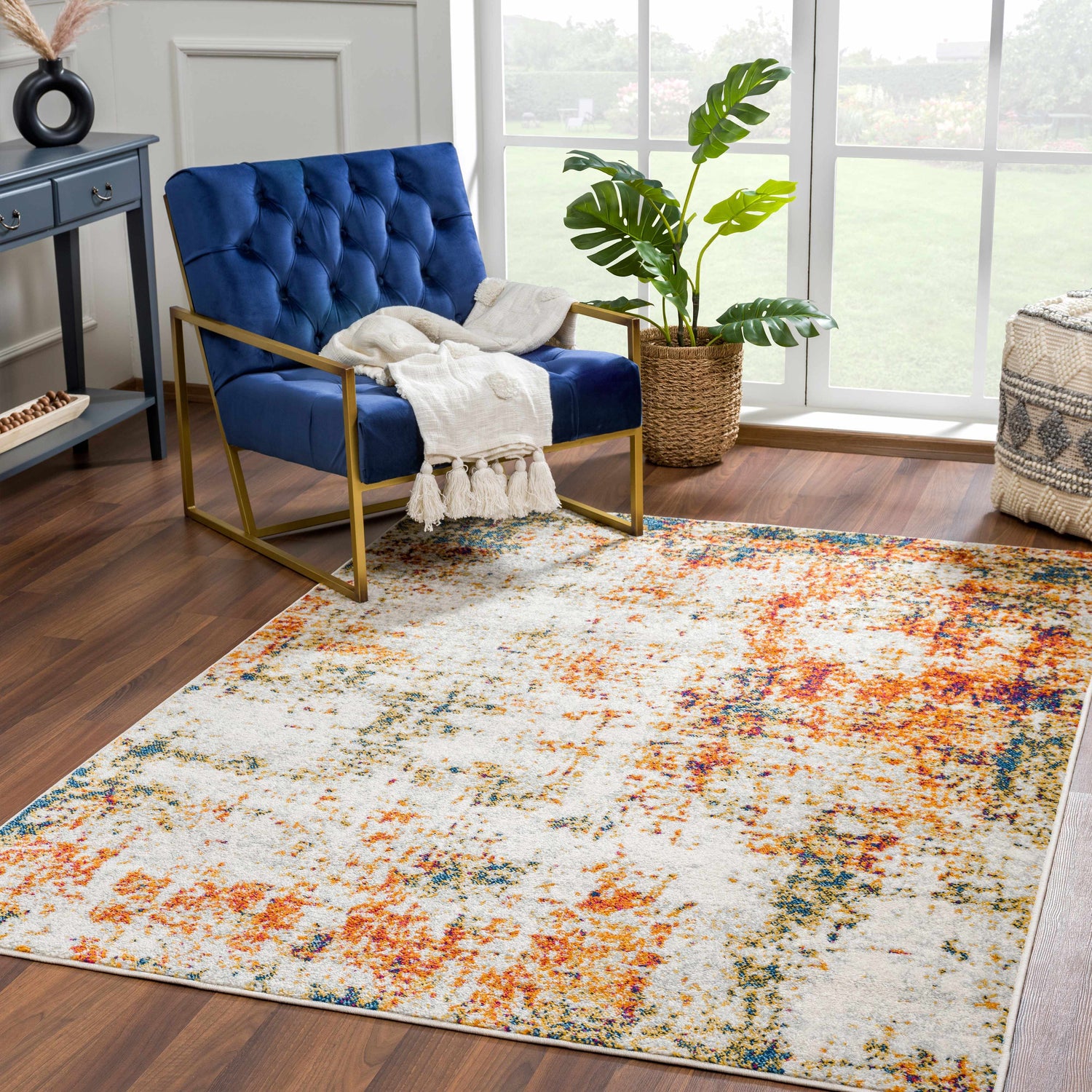 Living room scene with blue velvet chair and Istanbul Abstract Area Rug in blue, rust, and ivory. Roomscene-Rectangle