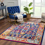 Living room scene with Istanbul Vintage Navy Area Rug, blue chair, and natural light. Roomscene-Rectangle