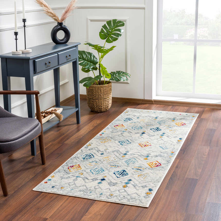 Entryway with Istanbul Aztec Area Rug runner, blue console table, monstera plant, and wood floors. Roomscene-Runner