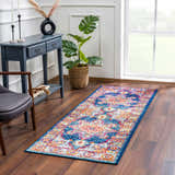 Entryway with Istanbul Medallion Blue & Orange Area Rug, blue console table, monstera plant, and gray chair. Roomscene-Runner