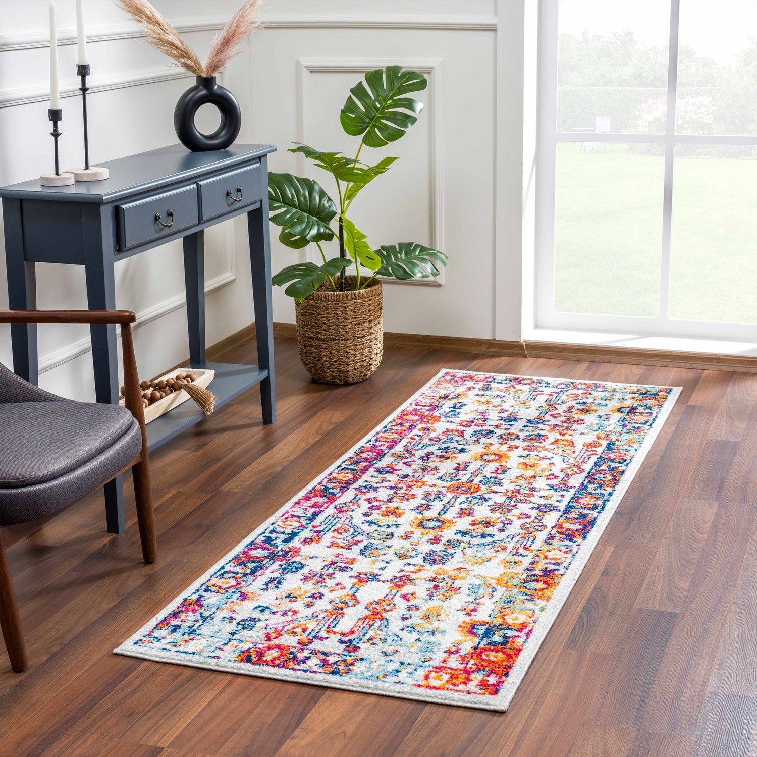 Entryway scene with Istanbul Colorful Rug runner. Bohemian style with light blue console table, monstera plant, and wood floors. Roomscene-Runner