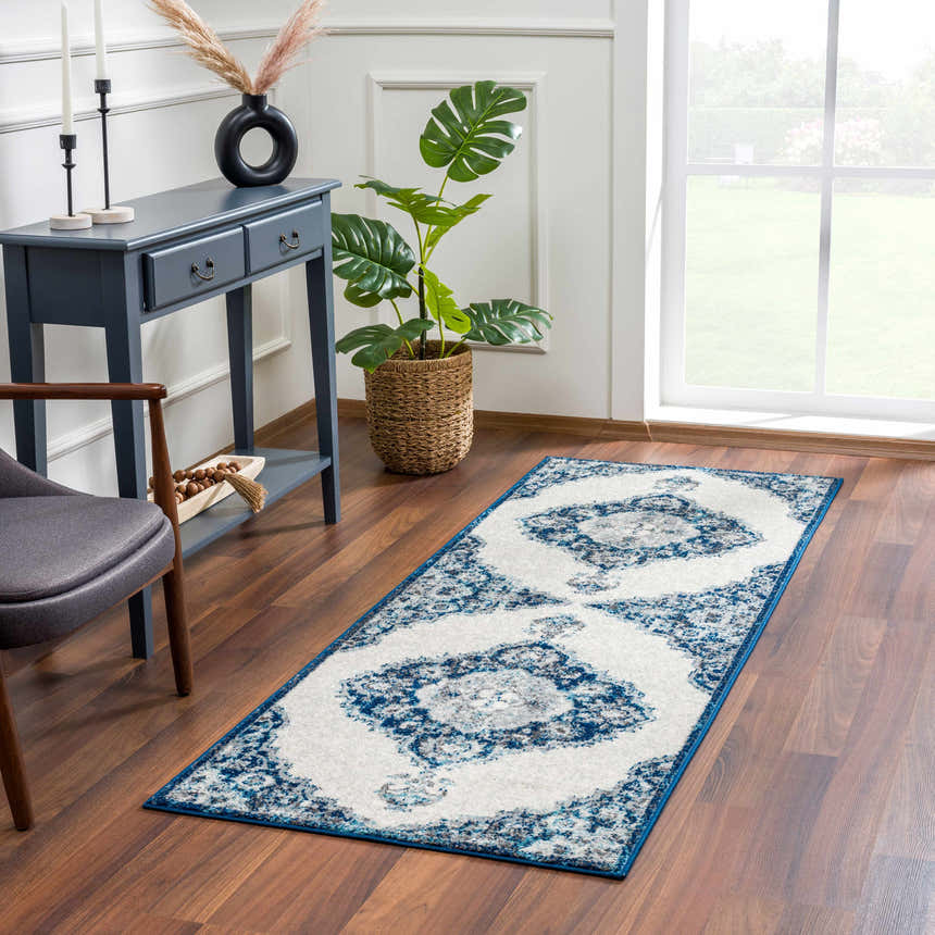 Entryway scene with Istanbul Blue Area Rug, navy console table, chair, and plant. Roomscene-Runner