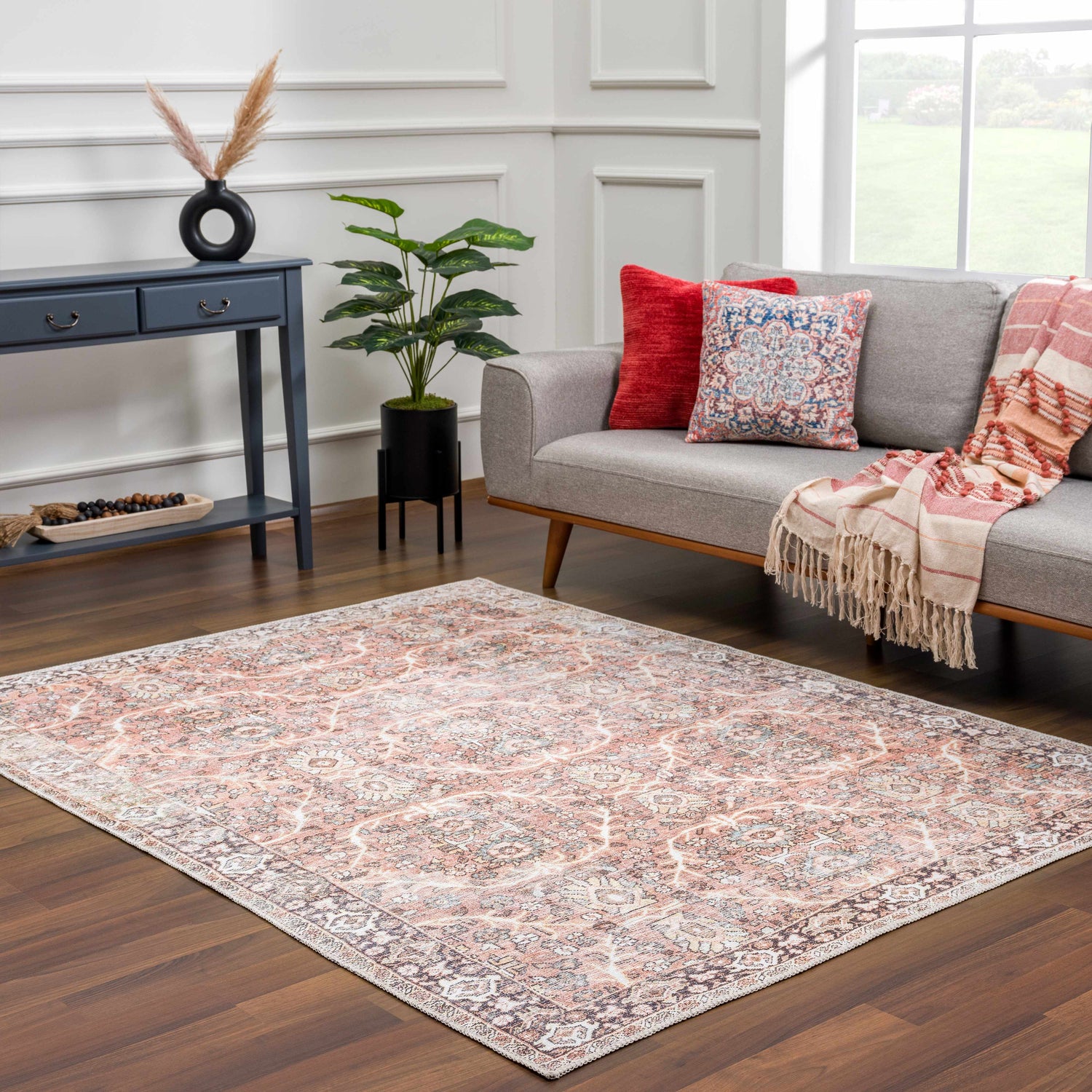 Living room scene with a Bian Washable Area Rug in peach and beige, styled with a gray sofa and blue console table. Roomscene-Rectangle