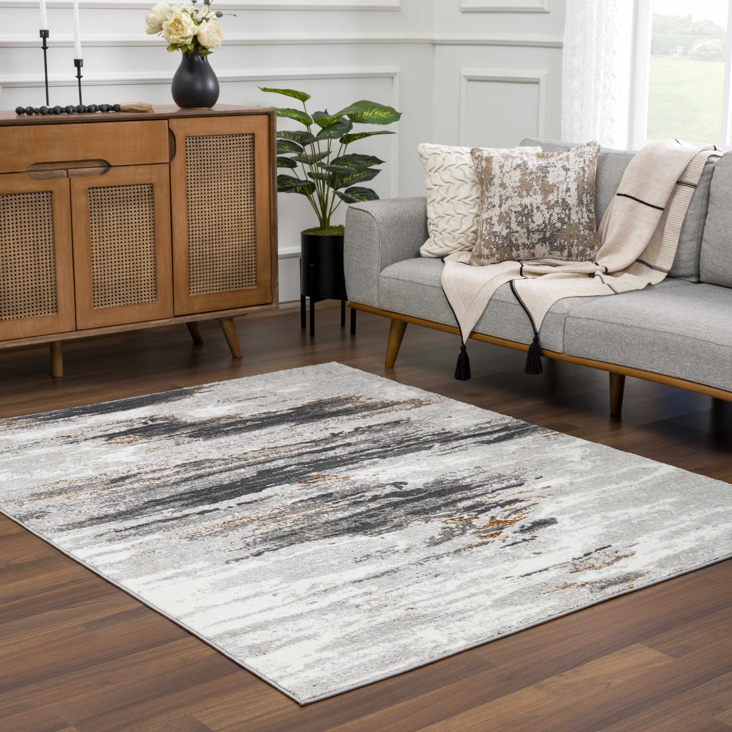 Living room scene with a gray sofa and the Live Marble Gray Area Rug on a dark wood floor. Roomscene-Rectangle
