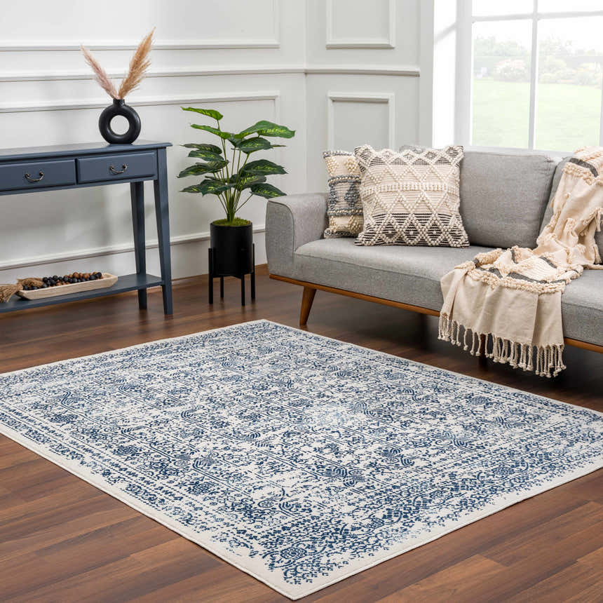 Living room scene with a blue and white Michie Blue Area Rug, gray sofa, and blue console table. Roomscene-Rectangle