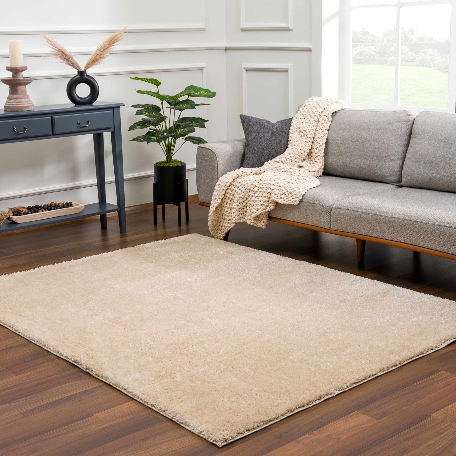 Living room scene with a Heavenly Dark Beige Area Rug, gray sofa, and dark wood floors. Roomscene-Rectangle