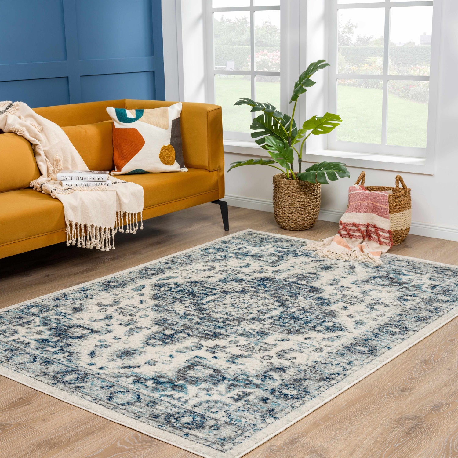 Living room scene with Istanbullu Blue Area Rug, gold sofa, and natural light. Roomscene-Rectangle