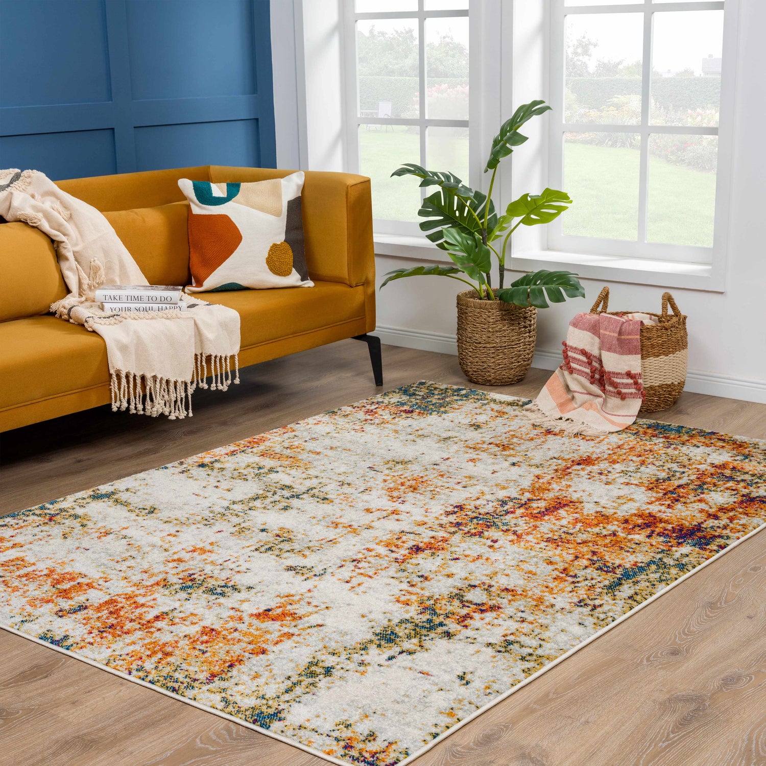 Living room scene with a mustard sofa and Istanbul Abstract Area Rug in blue, pink, ivory, gray, mustard, and rust. Roomscene-Rectangle