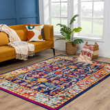 Living room scene with a navy, ivory, orange Istanbul Vintage Navy Area Rug, mustard sofa, and blue accent wall. Roomscene-Rectangle