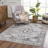 Living room scene with a gray chair and Liverpool Dark Gray Area Rug, creating a cozy, farmhouse-style space. Roomscene-Rectangle