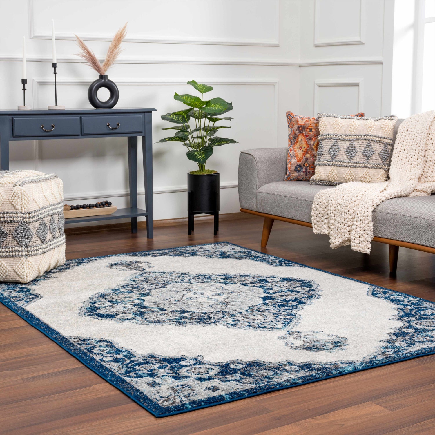 Living room scene with an ivory and navy Istanbul Blue Area Rug, gray sofa, and blue console table. Roomscene-Rectangle