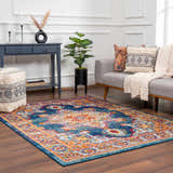 Living room scene with Istanbul Medallion Blue & Orange Area Rug, gray sofa, blue console table, and bohemian decor. Roomscene-Rectangle