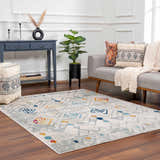 Living room with gray sofa, blue console table, and Istanbul Aztec Area Rug in colorful Southwestern style. Roomscene-Rectangle
