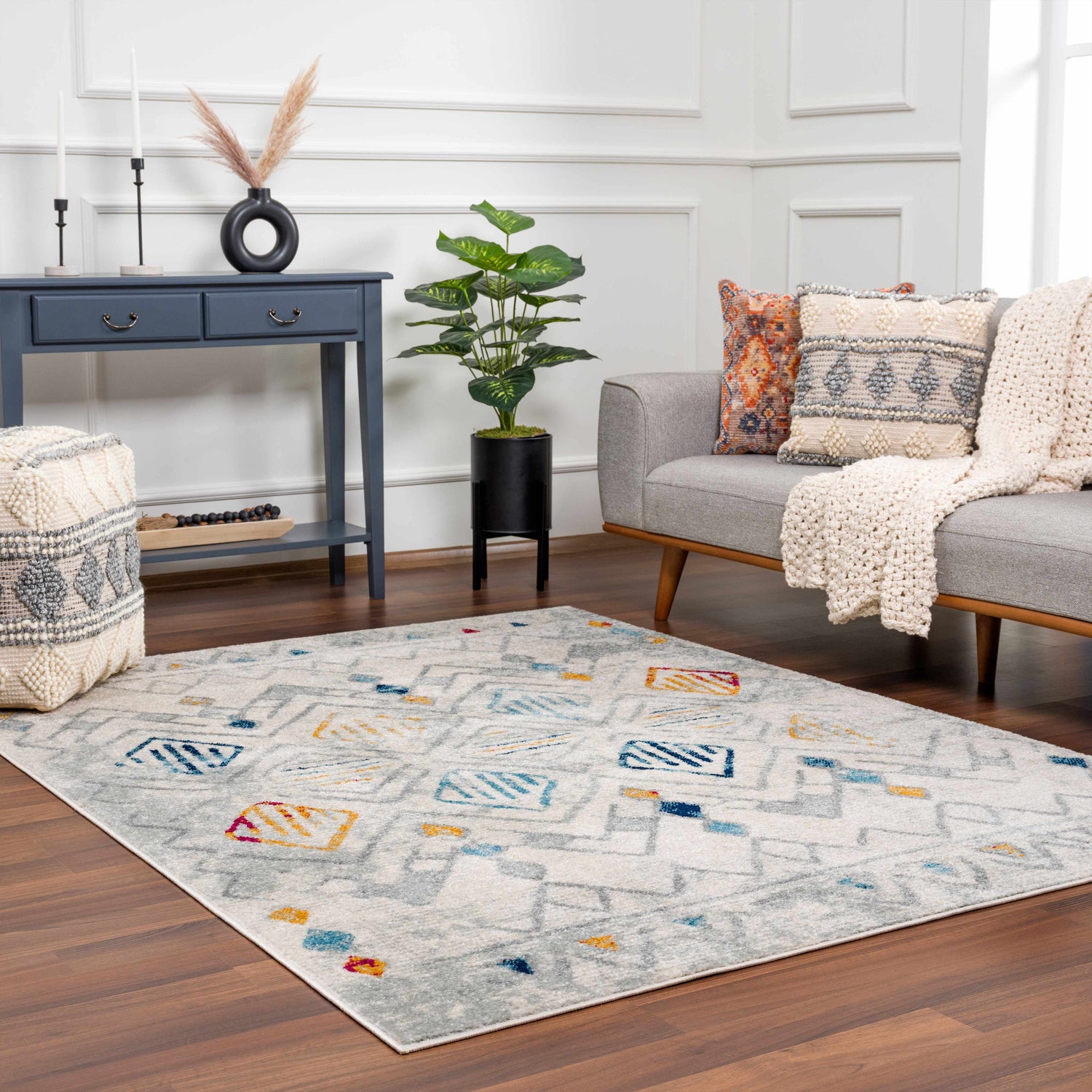Living room with gray sofa, blue console table, and Istanbul Aztec Area Rug in colorful Southwestern style. Roomscene-Rectangle