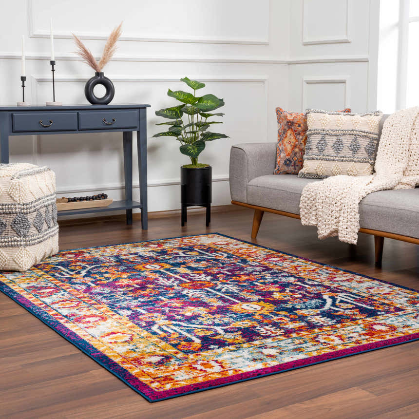 Living room scene with Istanbul Vintage Navy Area Rug, gray sofa, navy console table, and bohemian decor. Roomscene-Rectangle