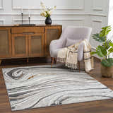 Living room scene with a Live Marble Dark Gray Area Rug, light gray chair, and wood cabinet. Roomscene-Rectangle