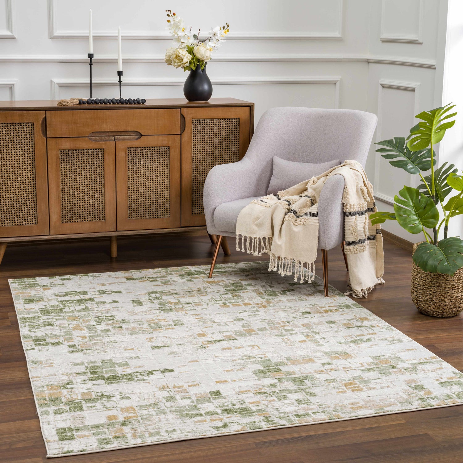 Living room scene with a Liveri Green Mosaic Rug, gray chair, and wooden cabinet. Roomscene-Rectangle