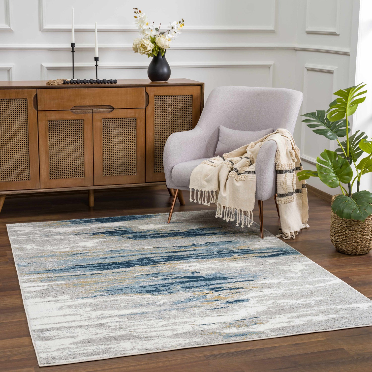 Living room scene with a Live Marble Blue Area Rug, gray chair, wood cabinet, and plant. Roomscene-Rectangle