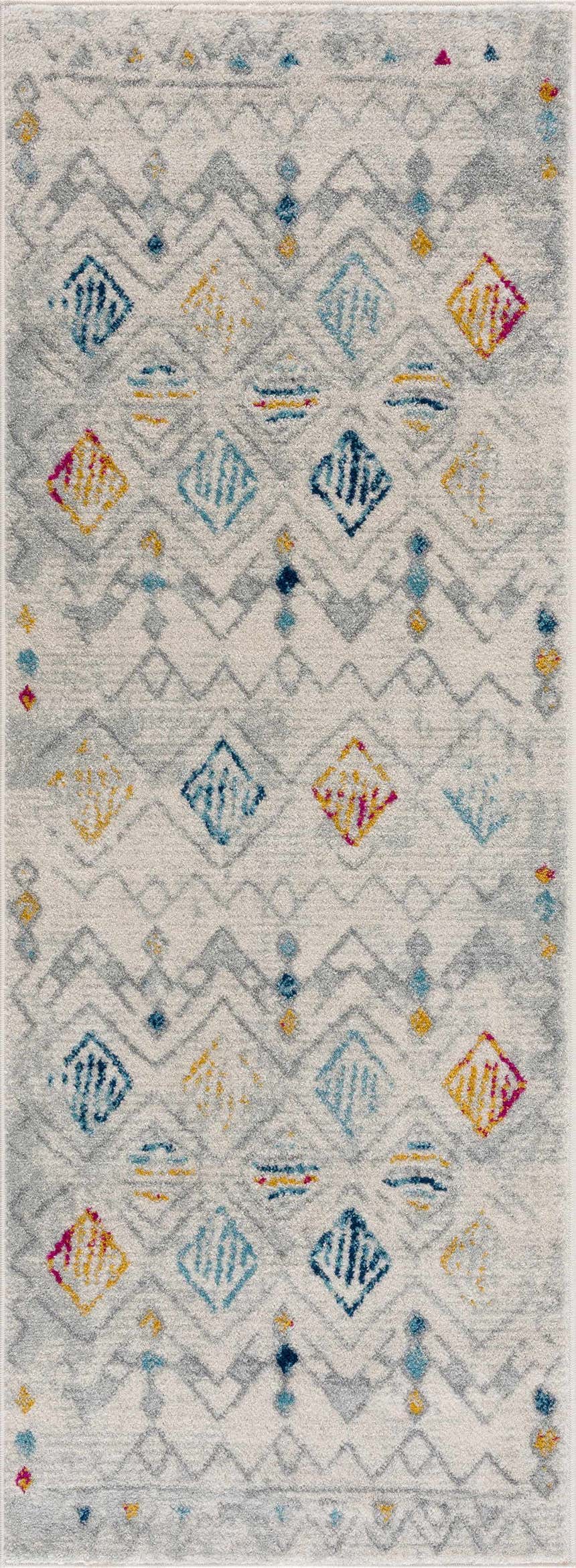 Close-up of Istanbul Aztec Area Rug. Features colorful diamond and geometric pattern in pink, blue, mustard, and gray. Design-Runner
