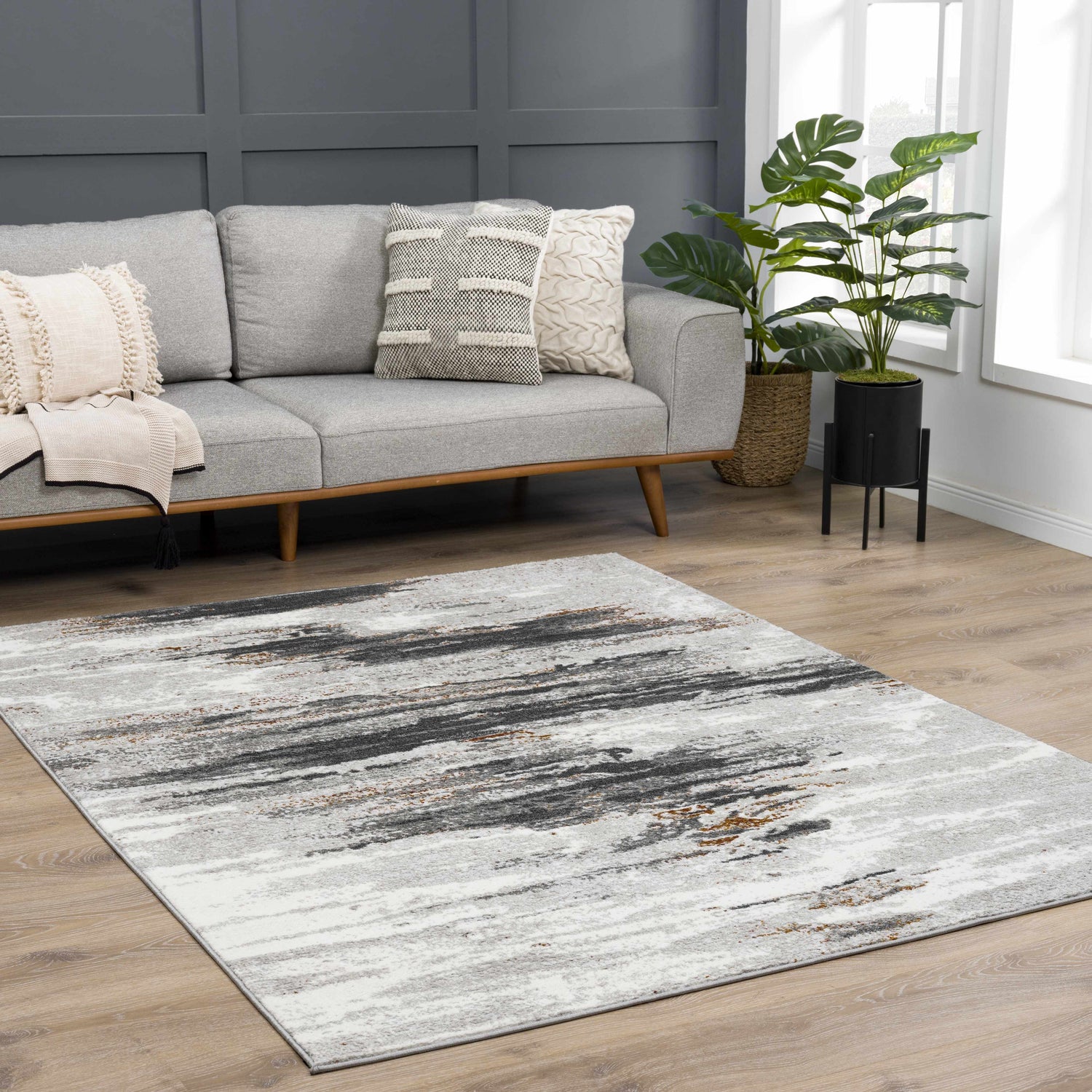 Living room scene with gray sofa and Live Marble Gray Area Rug with charcoal, rust, and off-white accents. Roomscene-Rectangle