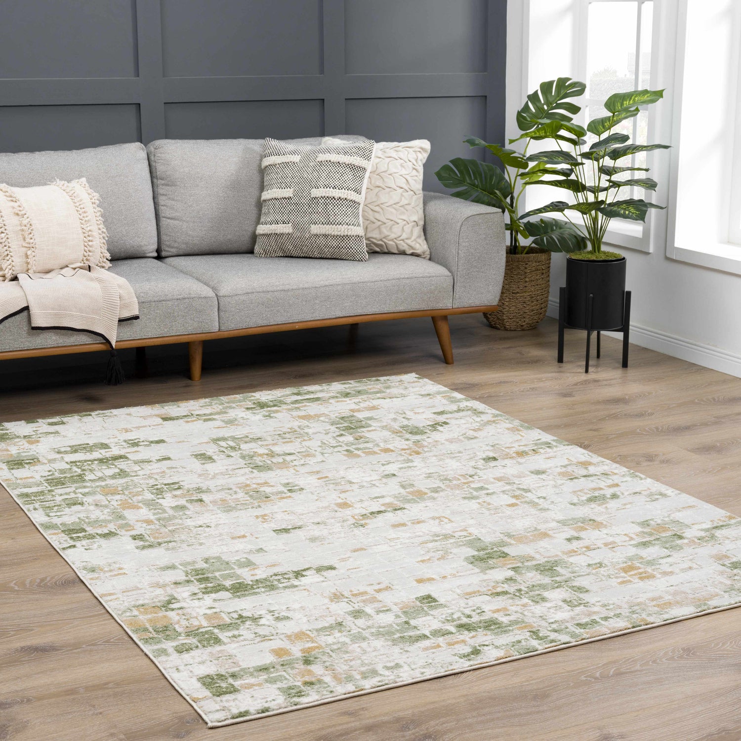 Living room with gray sofa and the Liveri Green Mosaic Rug, an abstract design in green and beige tones. Roomscene-Rectangle