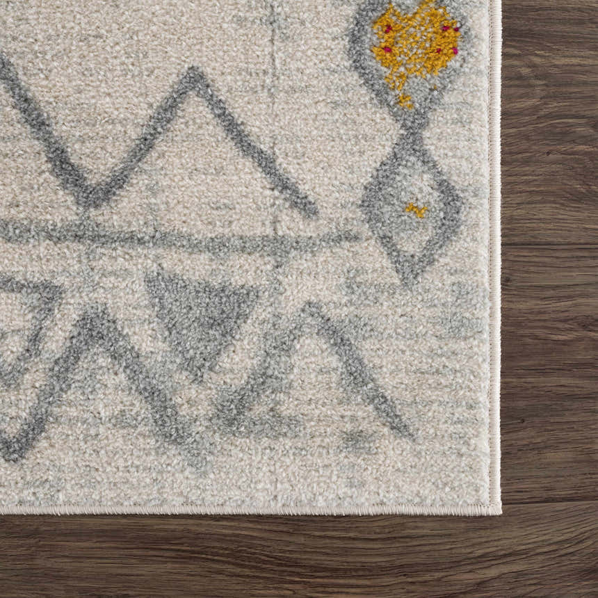Close up of the Istanbul Aztec Area Rug showing off-white, gray and mustard colors. Swatch