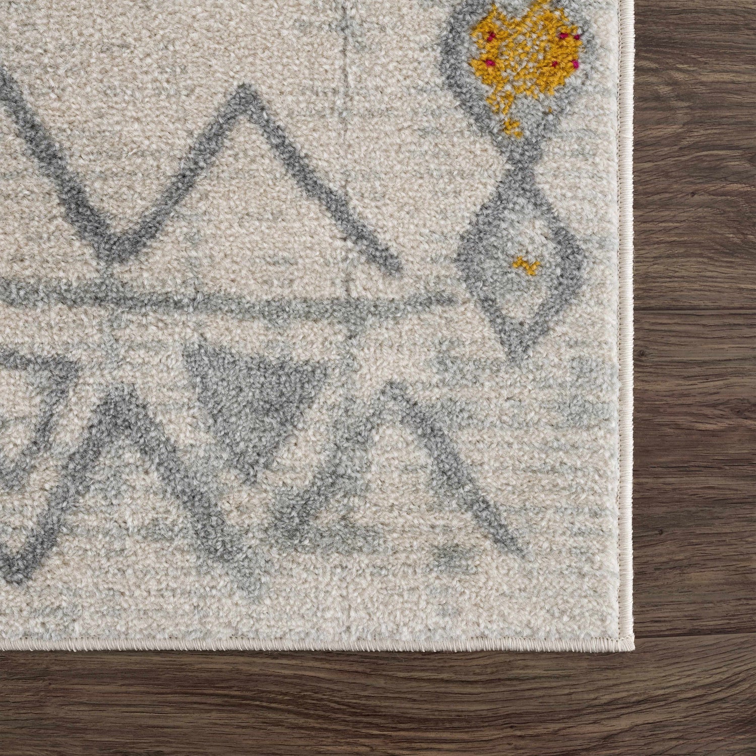 Close up of the Istanbul Aztec Area Rug showing off-white, gray and mustard colors. Swatch