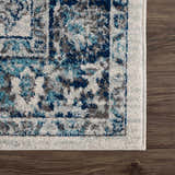 Close-up of the Istanbul Vintage Blue Area Rug showing its ivory, navy, and gray vintage pattern and soft texture. Swatch